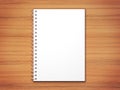 White 3d render blank spiral notepad on wooden desk texture.