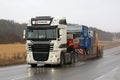 White DAF XF Special Transport along Highway in Snowfall Royalty Free Stock Photo