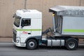 White DAF XF truck loading a white container trailer along Barcelona's Ronda Litoral