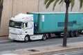 White DAF XF truck loading a white container trailer along Barcelona's Ronda Litoral