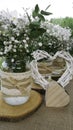 White daisy bouquet in glass jar and wattle white heart in green Royalty Free Stock Photo