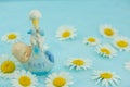 White daisy flower on blue background with baby boy statue Royalty Free Stock Photo