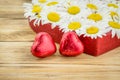 White daisy flower in heart shaped and red heart chocolates