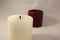 White and dark candles on the white background Royalty Free Stock Photo