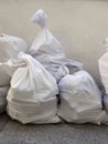 White debris raffia sack close up. White Canvas Membrane Plastic Bags With Construction Trash. Pile of plastic rubble sacks in the