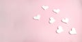 White decor hearts on pink background. Love minimalist composition for Valentines day