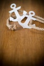 White decorative anchor on a wooden background Royalty Free Stock Photo