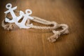 White decorative anchor on a wooden background Royalty Free Stock Photo