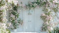 a white decorative entrance door adorned with a soft pink flowers garland, inviting viewers into a world of elegance and Royalty Free Stock Photo