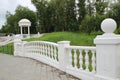 White decorative gazebo with a fence and a ladder