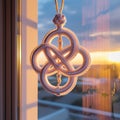 White Knot Ornament by Window with Sunset Light decorative hanging Royalty Free Stock Photo