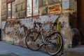 White decorative old bike with a basket of flowers against a brick wall. Copy space Royalty Free Stock Photo