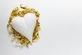 With porcelein heart with golden ribbon on white backgound