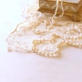 white delicate lace fabric and white pearls