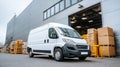 White delivery van parked in front of a warehouse loading dock. Royalty Free Stock Photo