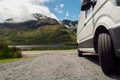 White delivery van parked off road. Small lake and mountains in the background. Delivery service in remote area concept. Connemara Royalty Free Stock Photo