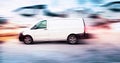 White delivery van speeding on the road