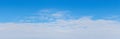 White dense clouds on a blue sky, panorama