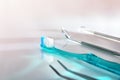 White dentist table with blue toothbrush and tools