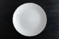 White designer plate on black background top view. Empty plate Royalty Free Stock Photo