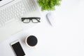 White desk office with laptop, smartphone and other work supplies with cup of coffee. Top view with copy space for input the text