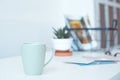 White desk table with copy space, supplies and coffee mug. Front view workspace and copy space