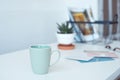 White desk table with copy space, supplies and coffee mug. Front view workspace and copy space