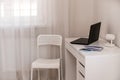 White desktop with laptop for remote work or study. Office computer workplace in home interior Royalty Free Stock Photo