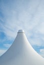 White detail of big top tent against a blue an cloudy sky Royalty Free Stock Photo
