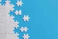 White details of puzzle on blue background Royalty Free Stock Photo