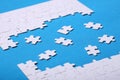 White details of a puzzle on a blue background. A puzzle is a pu Royalty Free Stock Photo