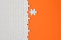 White details of puzzle on orange background Royalty Free Stock Photo