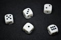 White dice,cube-shaped gaming accessories, on black background