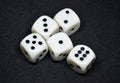 White dice,cube-shaped gaming accessories, on black background