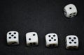 White dice,cube-shaped gaming accessories, on black background