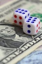 White dice are on a dollar bill of US dollars. The concept of gambling with rates in monetary unit