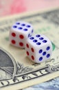 White dice are on a dollar bill of US dollars. The concept of gambling with rates in monetary unit