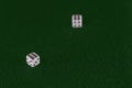 White dice on the green cloth of the table Royalty Free Stock Photo