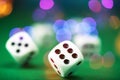 White dice on a green felt table with bokeh background Royalty Free Stock Photo