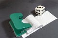 White dice.Note paper, hole punch and opposite organizer. Business and work concept. Stationery notebook with blank pages. Office