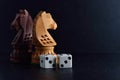 White dice pair and chess knights on black background Royalty Free Stock Photo