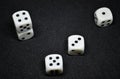 White dice,cube-shaped gaming accessories, on black background