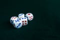 White dice thrown on a table. Dark green cloth.