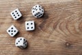 White dice on wooden table from above. Gambling devices. Game of chance concept.