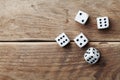 White dice on wooden table top view. Gambling devices. Game of chance concept.