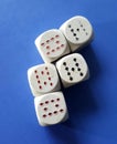 white dices with playing cards symbols on ble background Royalty Free Stock Photo