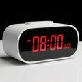White Digital Alarm Clock Displaying 0800 AM and 1600 digital clock time Royalty Free Stock Photo