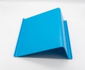 Blue plastic tablet stand isolated on white Royalty Free Stock Photo
