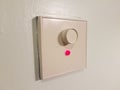 White dimmer on wall with red light