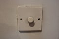 White dimmer switch white wall background